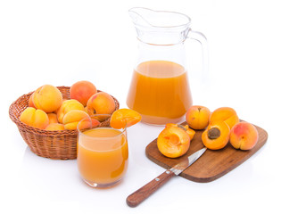 Poster - Glass and jug of apricot juice with a basket of apricots and sli