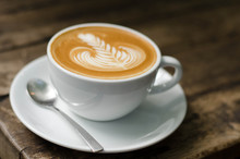 Foamy Latte Coffee On Dark Grained Wood Table Form Above