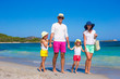 © travnikovstudio - Happy family of four on beach vacation