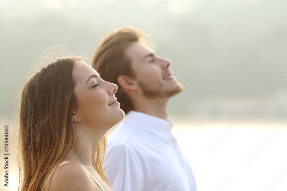 Couple of man and woman breathing deep fresh air - obrazy, fototapety, plakaty 
