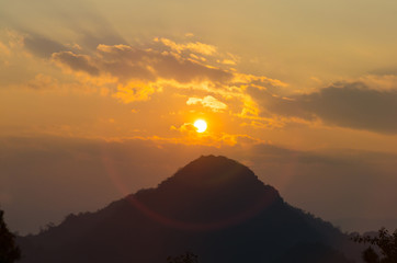 Wall Mural - sun with ring flare over mountain