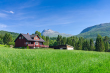 Typical Norwegian Village House Under The Mountains