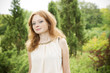 © staras - Portrait of redhead girl with blue eyes on nature