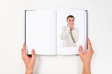 Wall Mural - Young man surprised printed on book