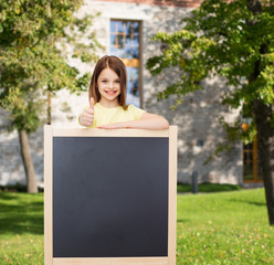 Sticker - happy little girl with blank blackboard