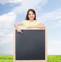 Sticker - happy little girl pointing finger to blackboard