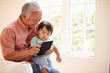 © Monkey Business - Grandfather And Grandson Using Digital Tablet Together