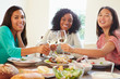 © Monkey Business - Group Of Female Friends Enjoying Meal At Home
