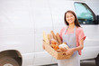 © Monkey Business - Female Baker Delivering Bread Standing In Front Of Van