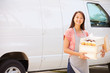 © Monkey Business - Female Baker Delivering Cakes Standing In Front Of Van