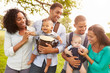 © Monkey Business - Two Families With Baby Carriers Walking In Park