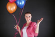 © Wisiel - woman with balloons over dark background smiling