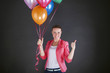 © Wisiel - woman with balloons over dark background smiling