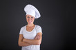 © Wisiel - woman chef smiling over dark background