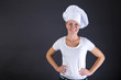 © Wisiel - woman chef smiling over dark background