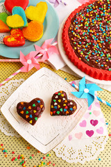 Wall Mural - Delicious rainbow cakes on plates, on bright background