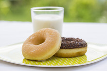 Donuts And Glass Of Milk In Garden