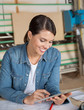 © Tyler Olson - Female Carpenter Using Digital Tablet At Table