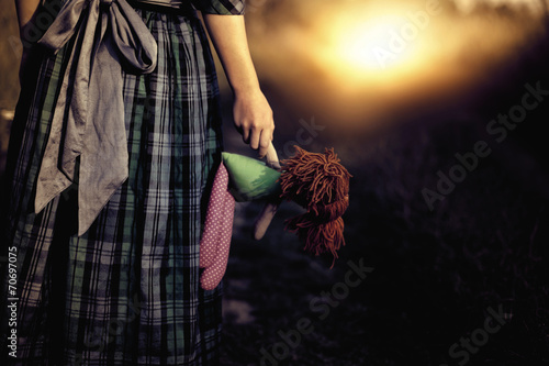 Photographie Loneliness - the girl with the doll goes to the light