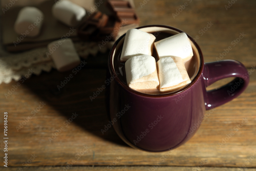 Hot chocolate with marshmallows in mug, on wooden background