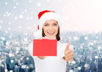 Wall Mural - woman in santa helper hat with blank red card