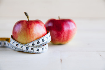 Wall Mural - Diet concept with red apple and measuring tape