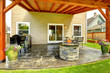 Patio area with tile floor and stone trimmed fire pit