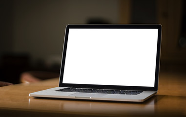 notebook with blank screen on table in home interior
