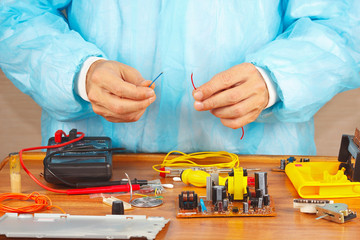 Wall Mural - Hands repairman servicing electronic devices in service workshop