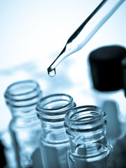 Wall Mural - laboratory research, dropping liquid to test tube