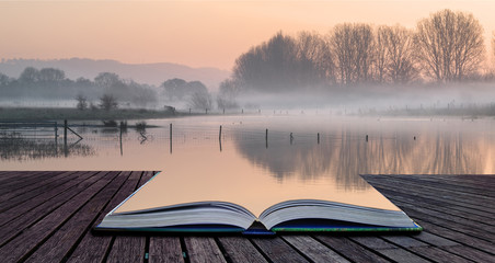 Canvas Print - Book concept Landscape of lake in mist with sun glow at sunrise