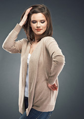 Casual style young woman posing on isolated studio background.