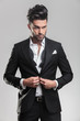 © Viorel Sima - young man wearing tuxedo closing his jacket