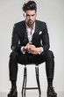 © Viorel Sima - Handsome young man in tuxedo sitting on a stool