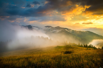 Wall Mural - amazing mountain landscape with fog and a haystack