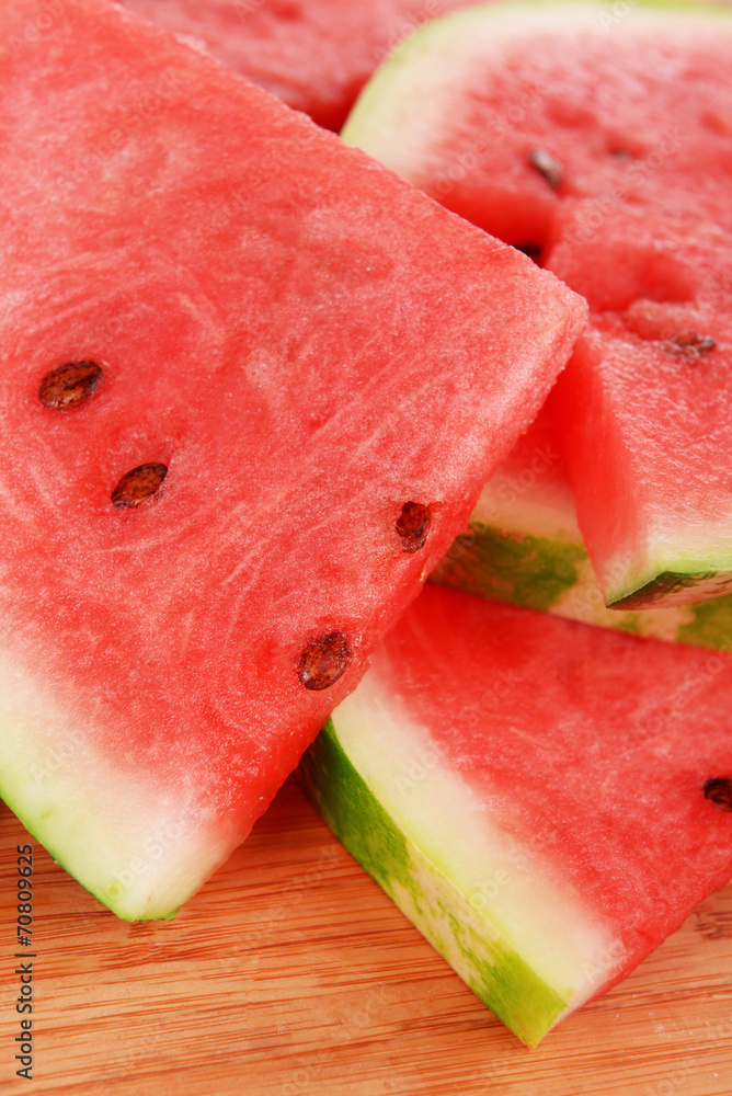 Slices of watermelon on wooden background