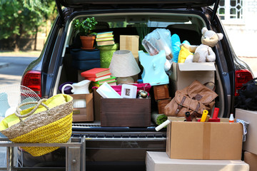 Wall Mural - Moving boxes and suitcases in trunk of car, outdoors