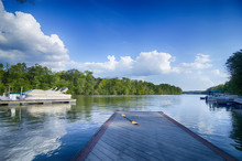 Boats At Dock On A Lake With Blue Sky