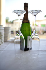 Glass goblets with sparkling wine bottle