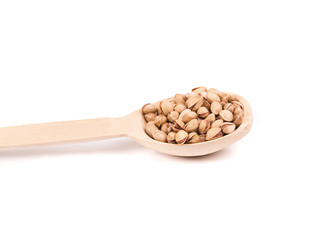 Wooden spoon with pistachios.