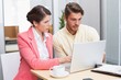 © WavebreakMediaMicro - Focused business people working together on laptop