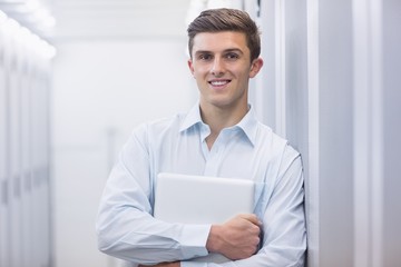 Wall Mural - Portrait of a smiling technician holding a laptop