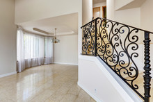 Emtpy House Interior. Marble Staircase With Black Wrought Iron R
