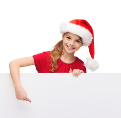 Canvas Print - child in santa helper hat with blank white board