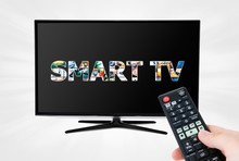 Hand With Remote Control Aiming Modern Smart TV Device