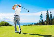 Man Playing Golf, Hitting Ball From The Tee