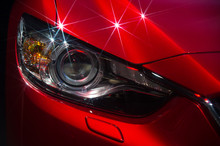 Hood And Headlights Of Sport Red Car With Silver Stars