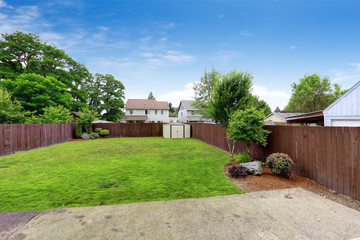 Spacious fenced backyard with shed