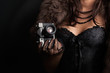 © merydolla - woman wearing corset and fur and holding vintage camera