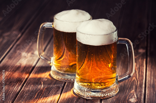 mug of beer on wooden background Canvas Print